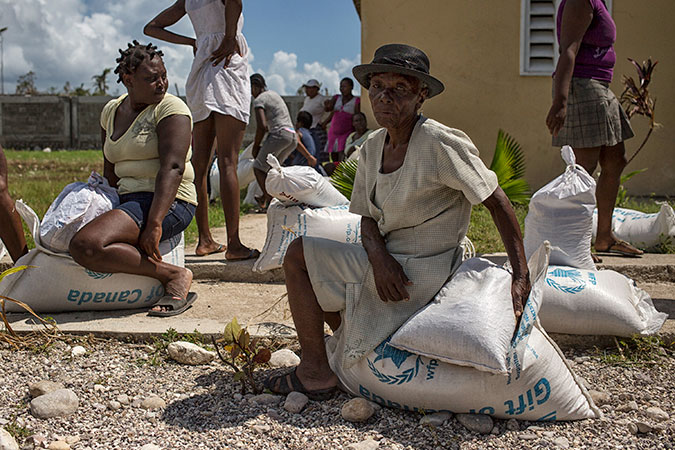 Women in the western Haitian town of Les Cayes collect food and emergency supplies in the wake of Hurricane Matthew, which struck the Caribbean nation in October 2016. Photo: UN Photo/Logan Abassi