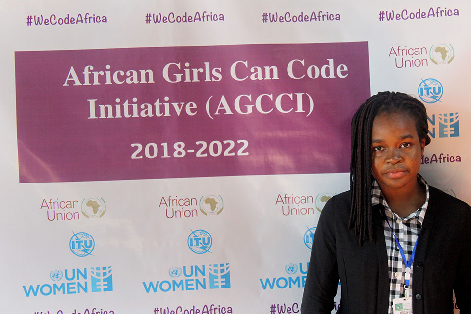 Eno Ekanem poses in front of a African Girls Can Code Initiative sign. Photo: UN Women/Faith Bwibo