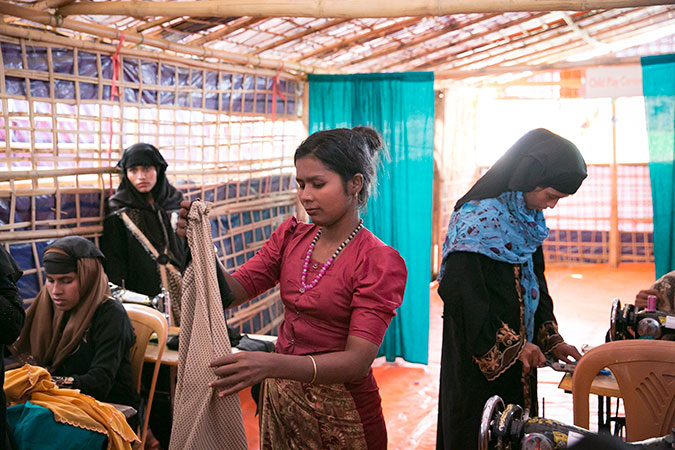 Students go about their projects at a UN Women-supported Action Aid Women Friendly Space in Balukhali Rohingya Refugee camp. Photo: UN Women/Allison Joyce