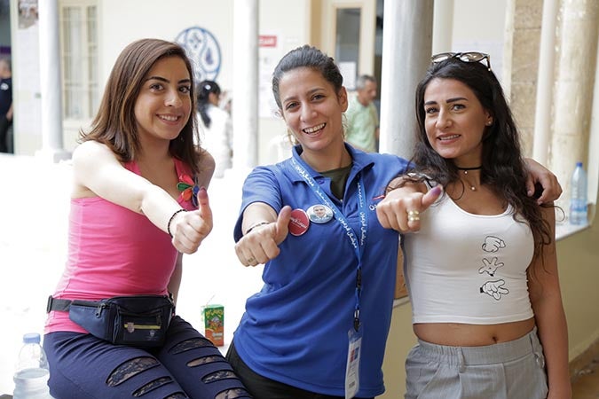 Women in Lebanon show off the electoral ink after voting in the parliamentary elections. Photo: UN Women/Jean Safi