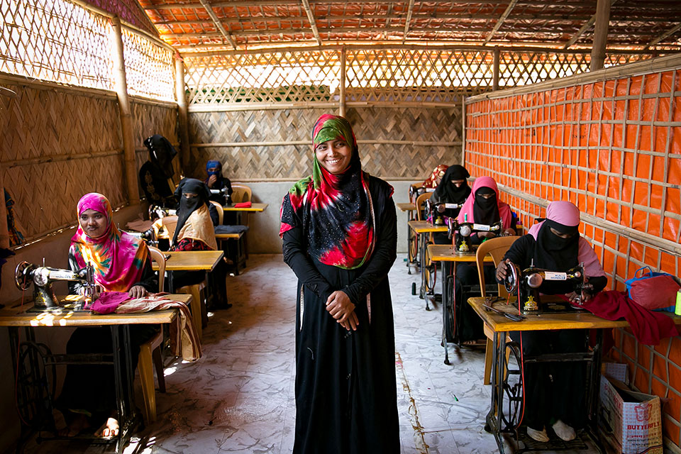 Noor Nahar stands in front of a classroom of Rohingya women refugees learning to sew in Cox's Bazar Bangladesh. Photo: UN Women/Allison Joyce