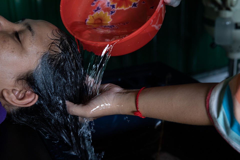 A women gets her hair washed at a salon in the Siem Reap province. Photo: UN Women/Stephanie Simcox