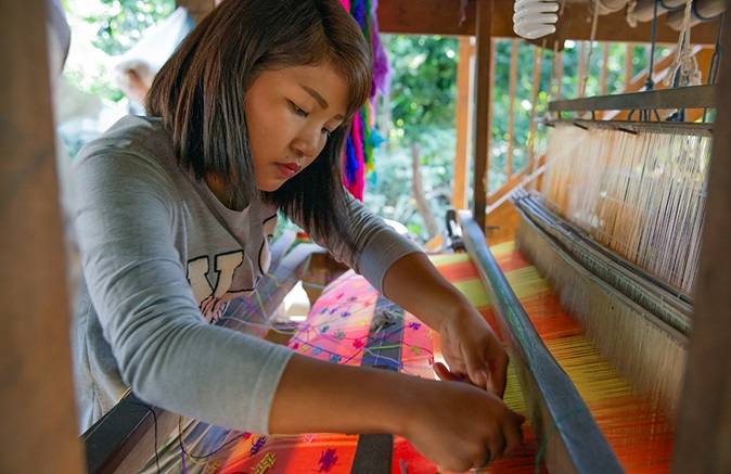 In Zee Lum Ward, Myitkyina, 27-year-old Ja Doi Lahpai—who was exploited in a mobile phone factory in China—has since learned how to weave, start a business and handle marketing and financial management. Photo: UN Women/Stuart Mannion