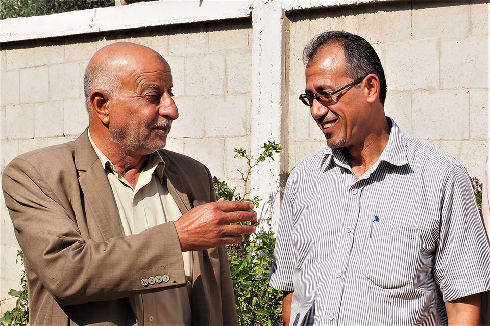 Abdel Naser Abu Te’ema, the “Muktar” and Wael Abu Ismael talking about the Muktar’s decision to not approve marriage under 18 for both boys and girls. Photo: UN Women/Eunjin Jeong