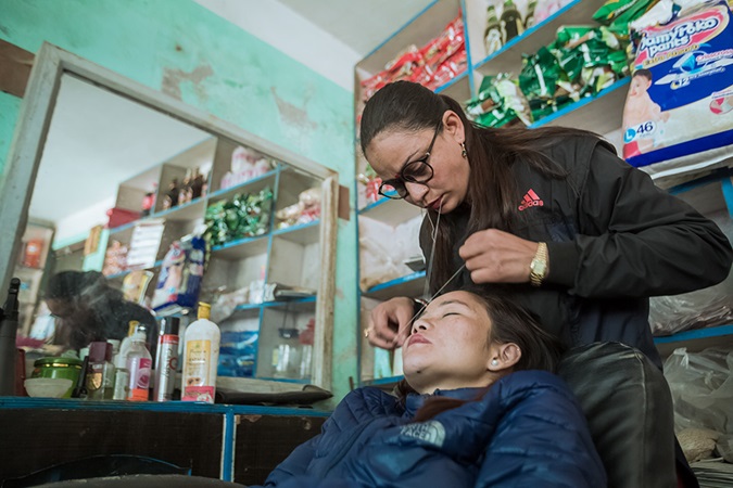 Sulochana Timalsina is the go-to person in her community. Women come to her for beauty treatments like eyebrow threading or hairdressing, as well as for advice on self-growth and empowerment. Photo: UN Women/Merit Maharjan