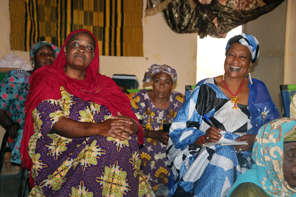 Mouna Awata (left), President of the Women Peace Hut speaks with other women. Photo: UN Women/Sandra Kreutzer