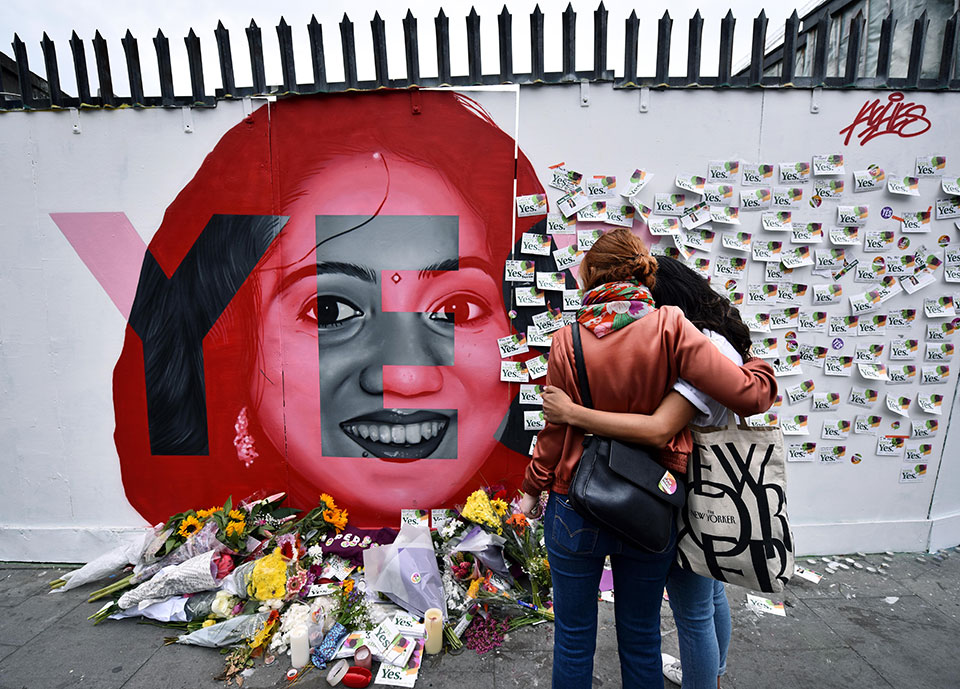 Two women look at written notes left on the Savita Halappanavar mural. Savita Halappanavar, who became the symbol of the Yes campaign, died aged 32, due to complications following a septic miscarriage in Galway in 2012. Photo: Getty Images/ Charles McQuillan