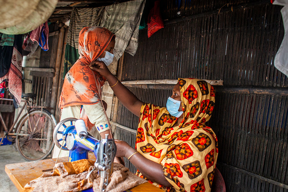 Women in Bangladesh work while wearing masks. Photo: UN Women/Fahad Kaizer
