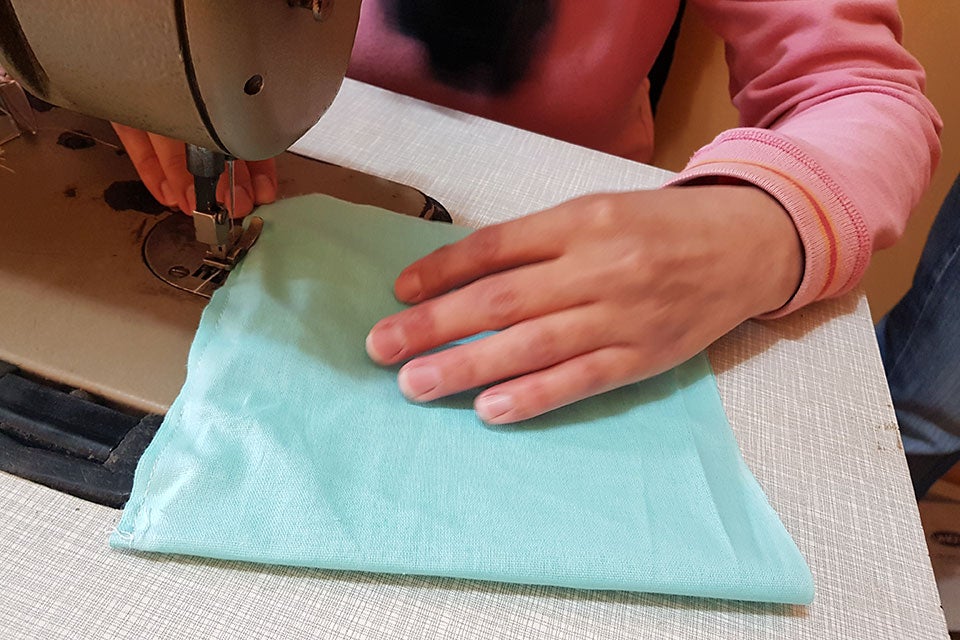 The protective face masks sewn by survivors will help protect essential workers including healthcare workers, taxi drivers, cleaners and others on the front line of the pandemic. Photo: UN Women/Tamara Savovic