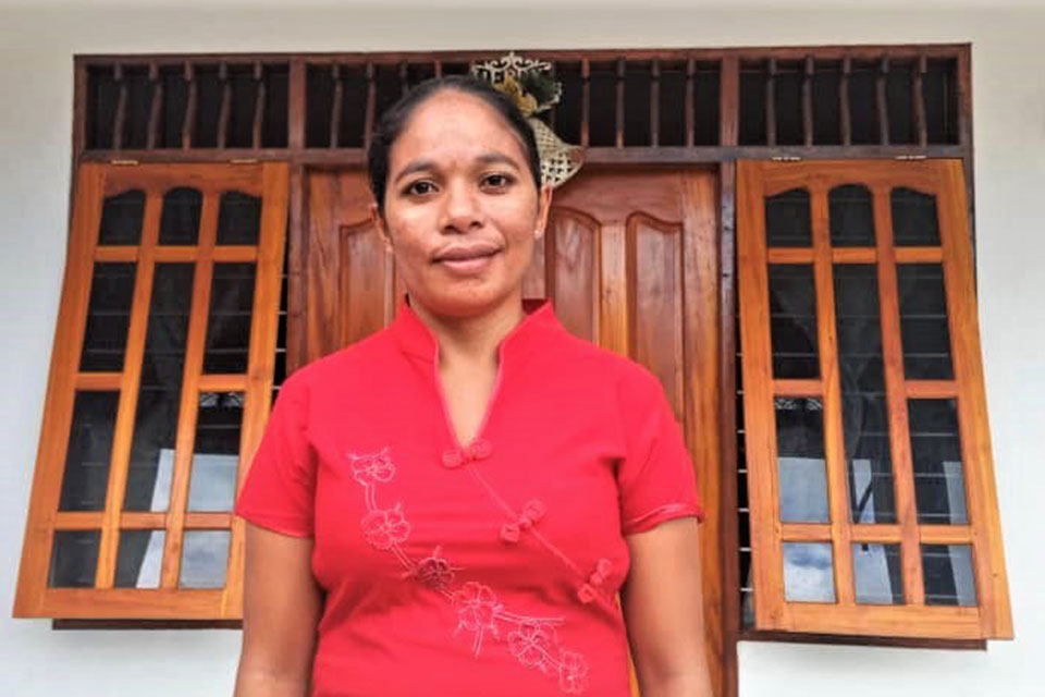 Ana Paula Soares stands in front of her family’s house in Ermera, Timor-Leste. Photo: Courtesy of Natercia Saldanha