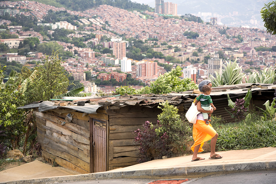 People are crowding into cities at record rates; many end up in poorer neighbourhoods with limited services and infrastructure. In this neighbourhood in Medellín, Colombia, most residents come from the countryside, having been displaced by conflict. Some services, like a cable car, have reached them, but they remain outside the more extensive city bus system. Photo: UN Women/Ryan Brown.