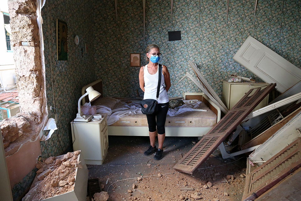 A woman standing in her destroyed house, Gemmayze, Beirut. August 5, 2020. Photo: Dar Al Mussawir