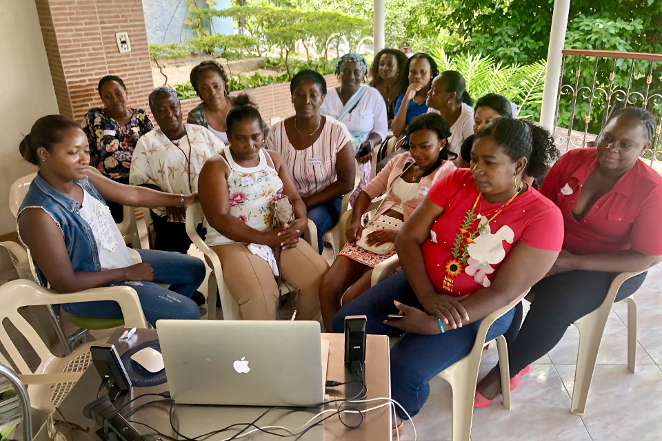 Women in Colombia watch back what they filmed as part of the first day of training in participatory video making. Photo: UN Women