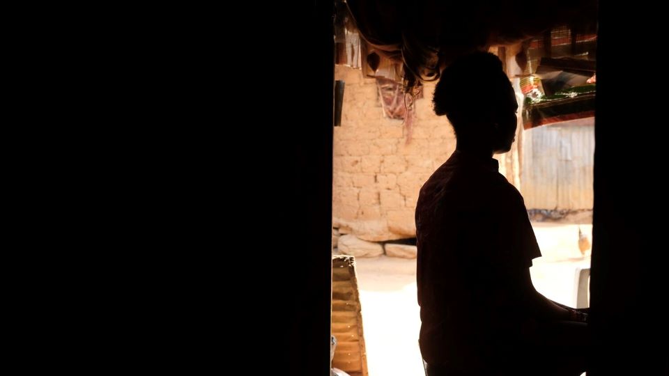silhouette of a young woman in a doorway. Photo: UNICEF