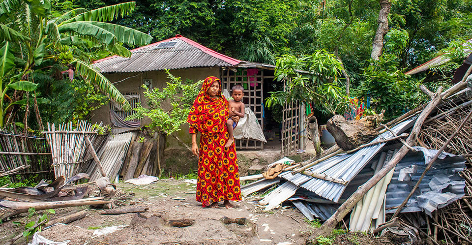 Cyclone Amphan uprooted the roof of Saleha Begum, 45, sending her and her family of five to a nearby cyclone shelter. A widow who had to give up day labour work to care for her family members, she received cash support from UN Women following the cyclone, which she used to pay off debts and obtain medical treatment for everyone in her family. Patarkhola Village, Satkhira District, Bangladesh, 2019. Photo: UN Women/Fahad Kaizer.