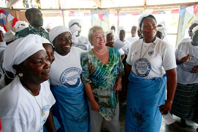 Michelle Bachelet visits a peace hut in Liberia during the IWD