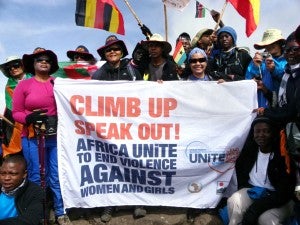 Climbers raise their flags to celebrate milestones as they make their way up Mount Kilimanjaro. (UN Women Photo) 