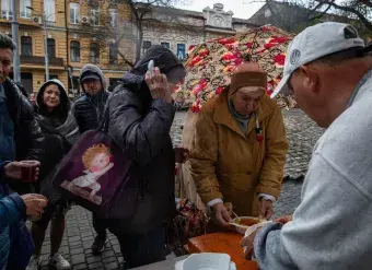 People wait to receive food in Odesa, Ukraine on 21 April, 2022. Photo: IMF Photo/Brendan Hoffman
