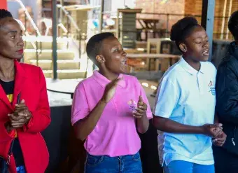 Young women for life movement members in Mamelodi township sing at the beginning of their group dialogue. Photo: UN Women/James Ochweri