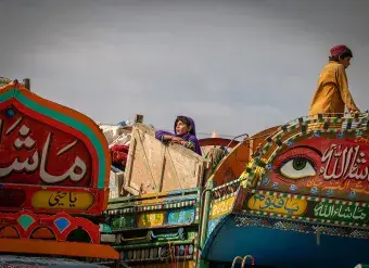 A young Afghan girl waits for her family to receive assistance at the Spin Boldak border crossing. Photo: IOM/Mohammad Osman Azizi.