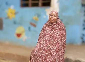 Munira Abdallah Abdallah in front of the childcare centre. Photo: UN Women