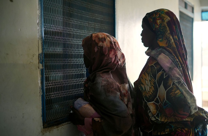On 2 May 2023 people wait for treatment at Fashir Reproductive health centre. The centre received WASH and health supplies from UNICEF. 