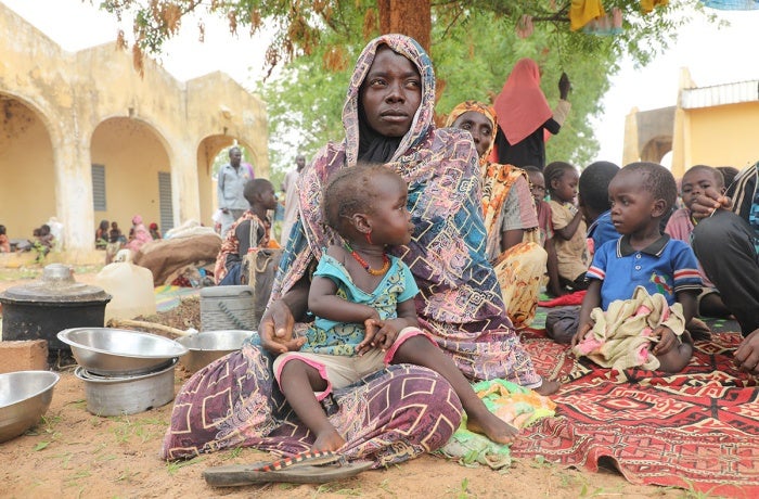 Mariam Djimé Adam, a refugee from Sudan with eight children, is seen in the yard of a secondary school in the neighbouring country of Sudan. 