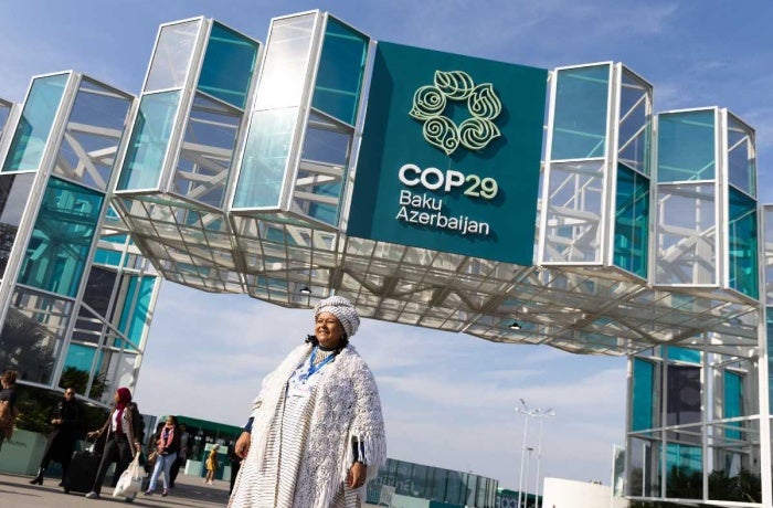 A COP29 attendee stands outside the venue in Baku, Azerbaijan. Photo: UN Climate Change/Kiara Worth.