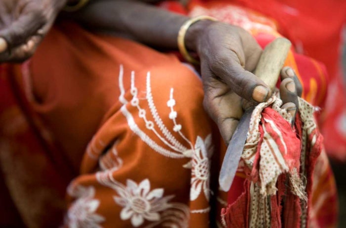 Boko Mohammed, a former excisor (a practitioner who performs female genital mutilation), holds the tool she used to perform the procedure at a community meeting in Kabele Village, inAmibara District, Afar Region.