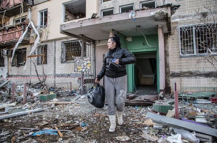 ukraine_undp_womenwalksthroughshelledbuildingentrance_1_1200x800.jpg