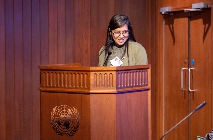 Sushmita S. Preetha speaks at a podium with the United Nations logo