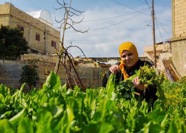 Aida Ghadban with her homegrown vegetables. Photo: UN Women/Lauren Rooney