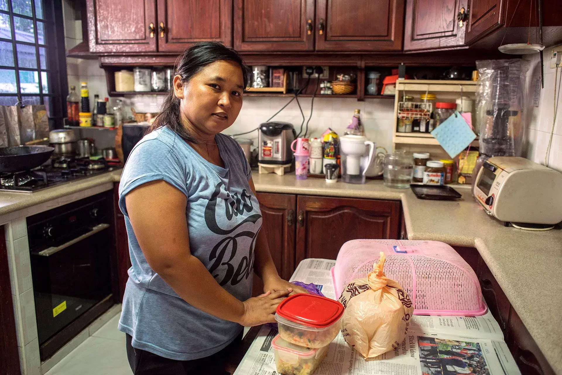 Nurachayatun an Indonesian domestic worker from Surabaya Java, prepares food inher employers kitchen after early morning grocery shopping.Photo: UN Women/Staton Winter