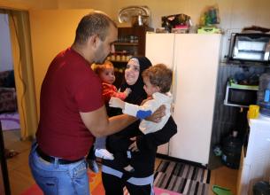 Ahmed Moustafa, a school principal, and Samiha Ghimrawi, a science teacher, at home in Tripoli, Lebanon, with their two children. Photo: UN Women/Marwan Tahtah.