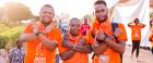 Three young activists wear orange during the sixteen days of activism against gender-based violence. 