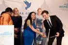 UN Women Acting Head Lakshmi Puri and moderator Ingo Nommsen hold the Cinema for Peace award to UN Women during the honorary dinner at Soho House on 12 July 2013 in Berlin.
