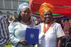 Baindu Massaquoi, UN Women Programme Specialist who was seconded to the United Nations Mission for Ebola Emergency Response during the emergency , and  Mary Okumu, UN Women Representative for Sierra Leone, accept a Silver Medal, honoring work during the E