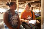 Lusiana Bulu, 38, talks to UN Women's Ellie van Baaren about the challenges she and other market vendors are facing in the wake of Tropical Cyclone Winston. Credit: UN Women/Murray Lloyd
