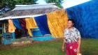 Luisa Siaos with traditional hand-painted cotton fabric or “elei lavava.” Photos courtesy of Samoa Victim Support Group.
