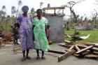 Women stand on the foundation of their home after it was destroyed by Tropical Cyclone Pam, Vanuatu, 2015. Photo: UN Women/Ellie van Baaren