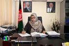 Justice Anisa Rasooli poses for a photo behind her desk. Photo: UN Women/Ishaq Ali Anis