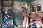 Birtukan Fekadu inside her home with sacks of grains she helped produce. Photo: UN Women