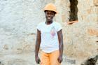Maira Assane Amade poses at a job site in her construction helmet. Photo: UN Women/Minna Vestlund