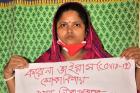 Rani Begum, domestic worker from Dhaka, is one of the many women in the informal economy who has lost work due to COVID 19.  She holds a sign calling for food security during the pandemic.  Credit: BNSK/Saad Sami 