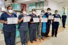 Health workers participating in UN Women India’s Second Chance Education programme display their “Certificate of Completion Essential Upskilling for Nurses on COVID-19 Pandemic Management”. Photo: UN Women